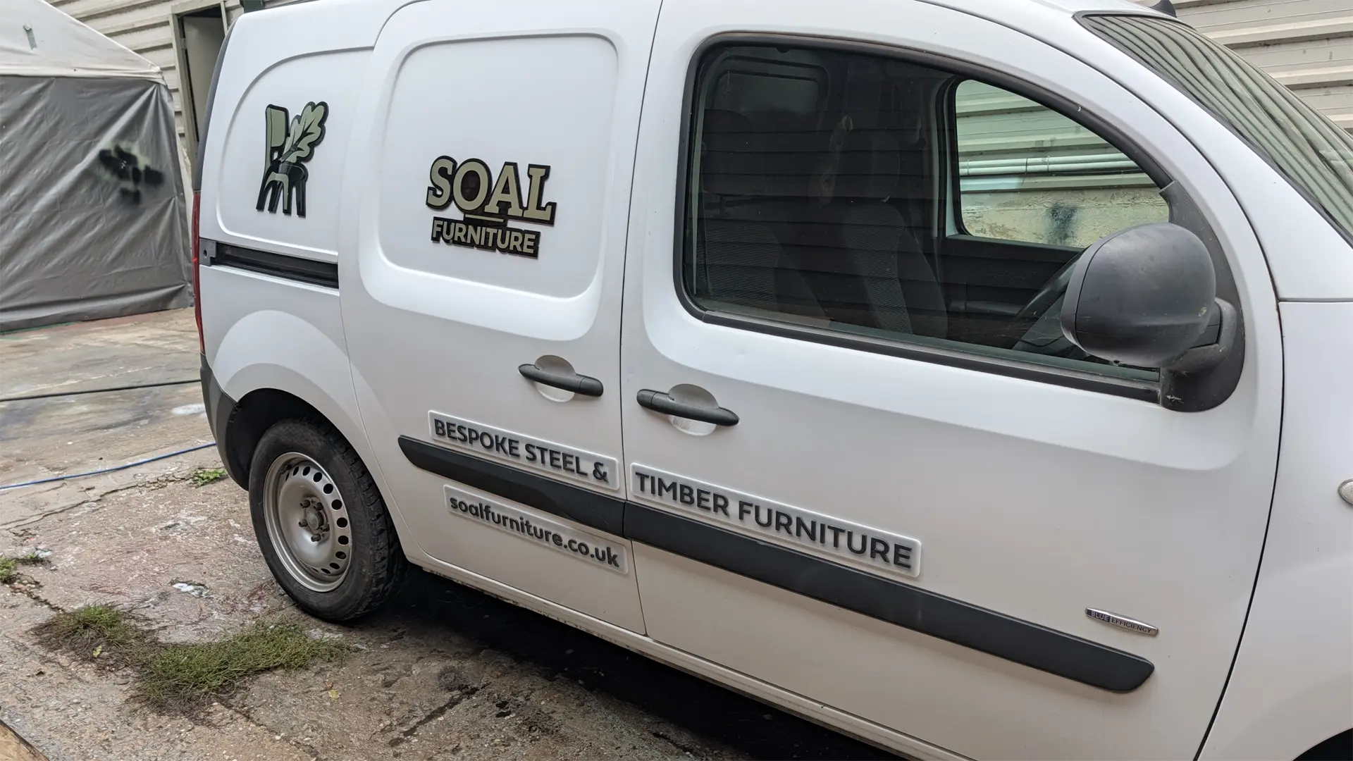 Finished SOAL Furniture van with 3D acrylic logo, bespoke steel and timber furniture signage, and website address