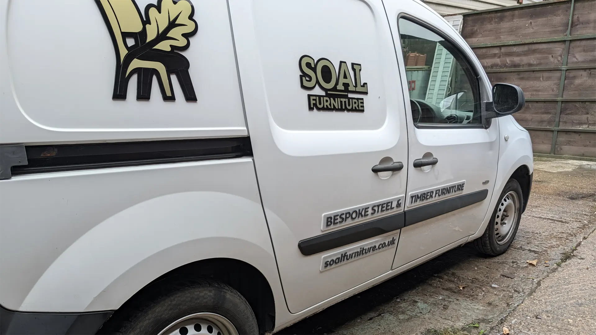 SOAL Furniture van showing 3D acrylic branding, bespoke steel and timber furniture signage, and website address